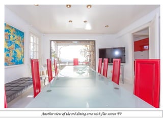 Another view of the red dining area with flat screen TV

 