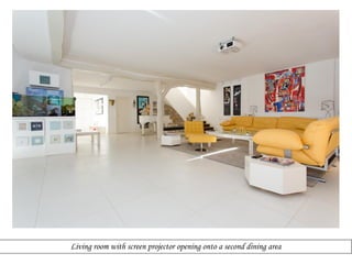 Living room with screen projector opening onto a second dining area

 