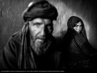 A young Afghan woman standing beside her much older husband. (Photograph by Majid Saeedi/Getty Images) 
 