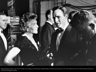 Actress Grace Kelly chatting w. her escort Paramount producer Don Hartman as they arrive at the 27th annual Academy Awards...