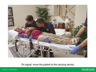 On signal, move the patient to the carrying device.
 