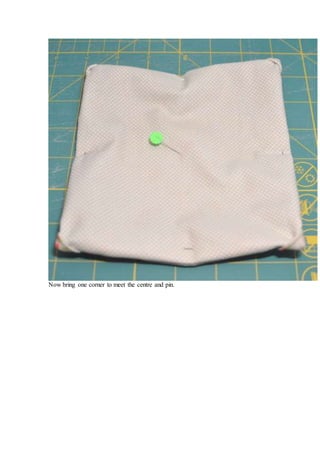 Now bring one corner to meet the centre and pin.
 