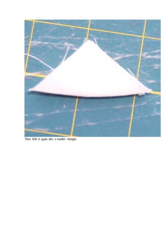 Then fold it again into a smaller triangle.
 