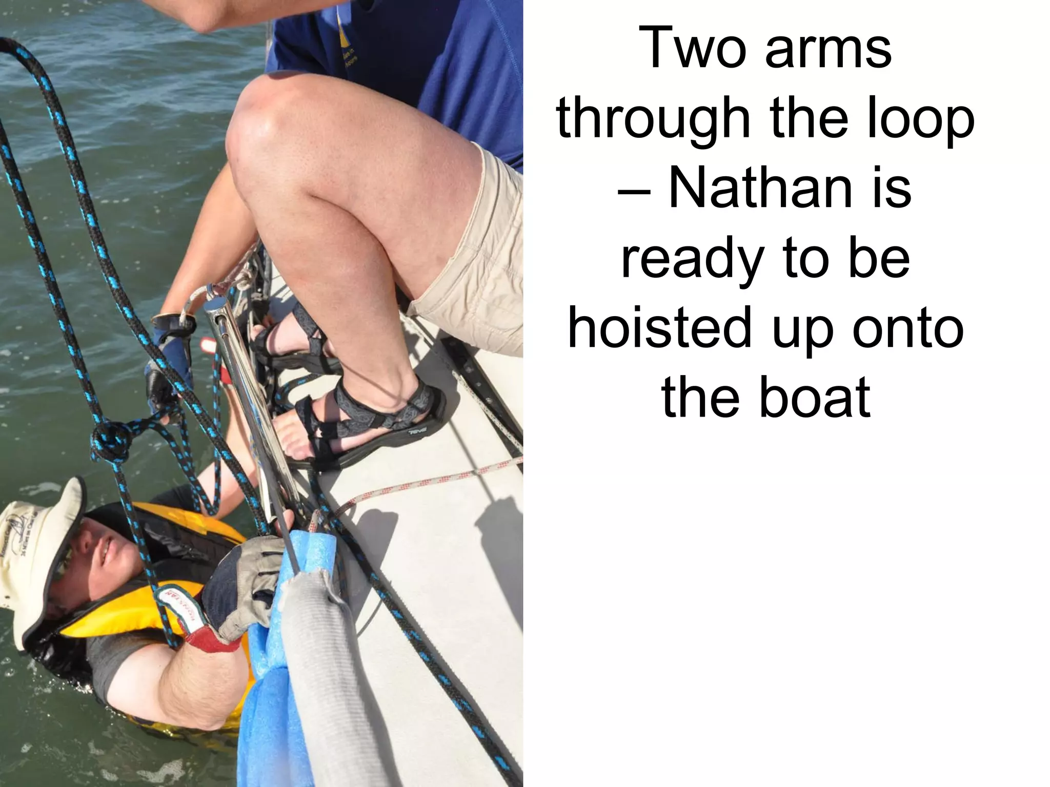 Two arms through the loop – Nathan is ready to be hoisted up onto the boat 