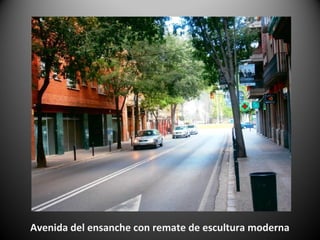 Avenida del ensanche con remate de escultura moderna
 