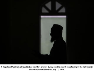 A Nepalese Muslim is silhouetted as he offers prayers during the the month-long fasting in the holy month
of Ramadan in Ka...