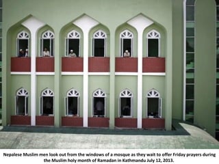Nepalese Muslim men look out from the windows of a mosque as they wait to offer Friday prayers during
the Muslim holy mont...