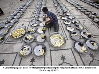 A volunteer prepares plates for Iftar (breaking fast) during the holy month of Ramadan at a mosque in
Karachi July 26, 201...