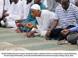 Muslim faithful take part in prayers during the I'takaf, a spiritual retreat in a mosque that is usually held during
the l...