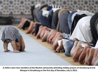 A child is seen near members of the Muslim community attending midday prayers at Strasbourg Grand
Mosque in Strasbourg on ...