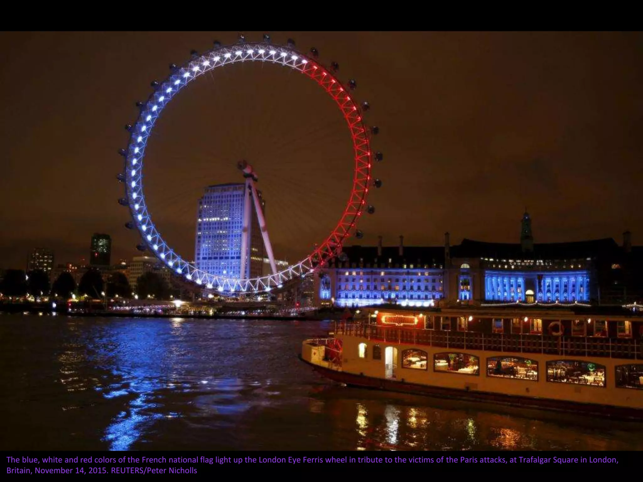 The blue, white and red colors of the French national flag light up the London Eye Ferris wheel in tribute to the victims of the Paris attacks, at Trafalgar Square in London,
Britain, November 14, 2015. REUTERS/Peter Nicholls
 