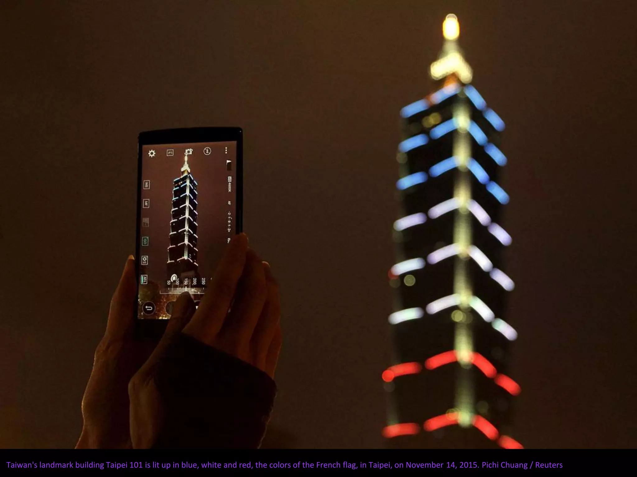 Taiwan's landmark building Taipei 101 is lit up in blue, white and red, the colors of the French flag, in Taipei, on November 14, 2015. Pichi Chuang / Reuters
 
