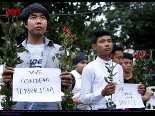 People attend a memorial to pay tribute to the victims of the Paris attacks, at the official residence for the French ambassador to Myanmar in Yangon, November 15, 2015.
REUTERS/Olivia Harris
 