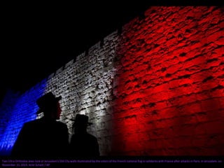 Two Ultra-Orthodox Jews look at Jerusalem's Old City walls illuminated by the colors of the French national flag in solidarity with France after attacks in Paris, in Jerusalem, on
November 15, 2015. Ariel Schalit / AP
 
