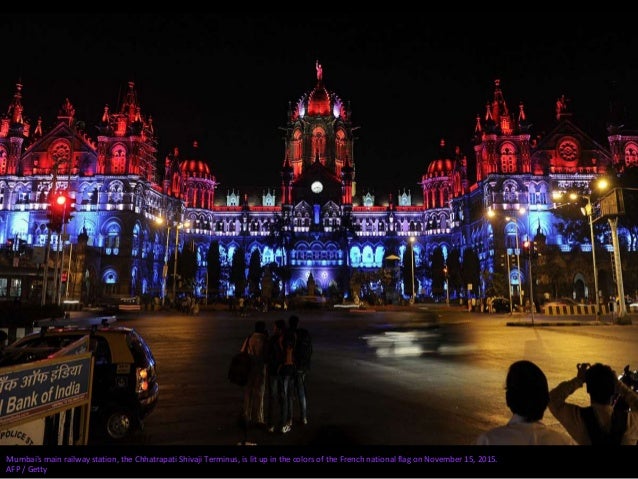 The colors of the French flag light up the spire on One World Trade as a French flag hangs from an arch in Washington Squa...