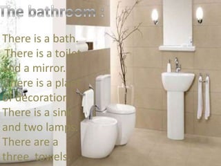 There is a bath.
,There is a toilet
and a mirror.
,There is a plant
of decoration.
There is a sink
and two lamps.
There are a
three towels.
 