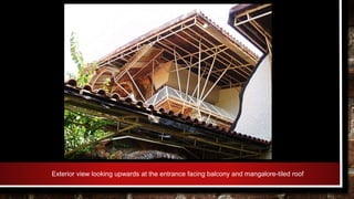 Exterior view looking upwards at the entrance facing balcony and mangalore-tiled roof
 