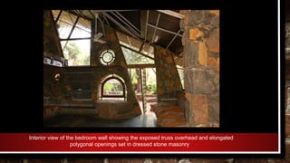 Interior view of the bedroom wall showing the exposed truss overhead and elongated
polygonal openings set in dressed stone masonry
 