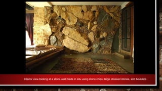 Interior view looking at a stone wall made in situ using stone chips, large dressed stones, and boulders
 