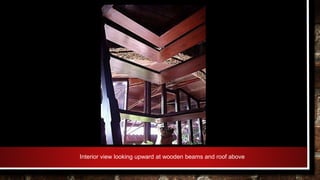 Interior view looking upward at wooden beams and roof above
 