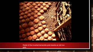 Detail of the inverted terracotta pots beside an old iron
gate
 