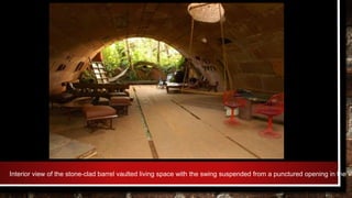 Interior view of the stone-clad barrel vaulted living space with the swing suspended from a punctured opening in the va
 