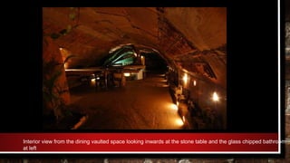 Interior view from the dining vaulted space looking inwards at the stone table and the glass chipped bathroom
at left
 
