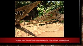 Exterior detail of the wooden gates and smooth stone pavings at the entrance
 