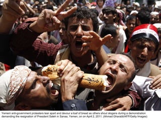 Yemeni anti-government protesters tear apart and devour a loaf of bread as others shout slogans during a demonstration demanding the resignation of President Saleh in Sanaa, Yemen, on on April 2, 2011. (Ahmad Gharabli/AFP/Getty Images)  