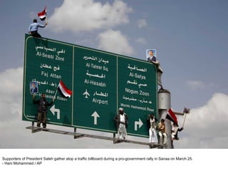 Supporters of President Saleh gather atop a traffic billboard during a pro-government rally in Sanaa on March 25.  - Hani Mohammed / AP  