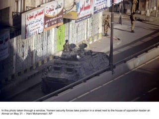 In this photo taken through a window, Yemeni security forces take position in a street next to the house of opposition leader al-Ahmar on May 31  -  Hani Mohammed / AP  