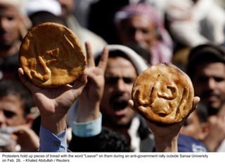 Protesters hold up pieces of bread with the word "Leave!" on them during an anti-government rally outside Sanaa University  on Feb. 26.  - Khaled Abdullah / Reuters  