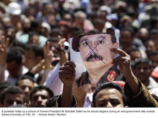 A protester holds up a picture of Yemeni President Ali Abdullah Saleh as he shouts slogans during an anti-government rally outside Sanaa University on Feb. 24.  - Ammar Awad / Reuters  