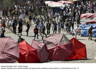 Ahmad Gharabli / AFP - Getty Images Regime loyalists throw stones towards anti-government protesters during clashes in central Sanaa on Feb. 17. 