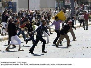 Ahmad Gharabli / AFP - Getty Images Anti-government protesters throw stones towards regime loyalists during clashes in central Sanaa on Feb. 17. 