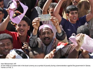 Hani Mohammed / AP A man holds up a bank note in the local currency as a symbol of poverty during a demonstration against the government in Sanaa, Yemen on Feb. 3. 
