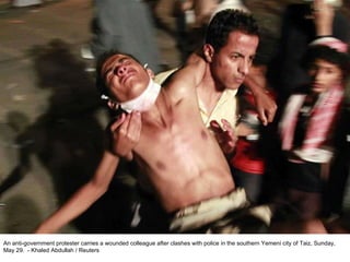 An anti-government protester carries a wounded colleague after clashes with police in the southern Yemeni city of Taiz, Sunday, May 29.  - Khaled Abdullah / Reuters  