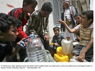 A Yemeni boy, right, gestures as he and others wait to collect water at a water point, as the city suffers from a shortage of water, in Sanaa, Yemen, Saturday, May 28.  - Saif Abduallah / AP  