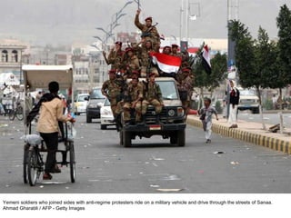 Yemeni soldiers who joined sides with anti-regime protesters ride on a military vehicle and drive through the streets of Sanaa.  Ahmad Gharabli / AFP - Getty Images  