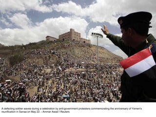 A defecting soldier waves during a celebration by anti-government protesters commemorating the anniversary of Yemen's reunification in Sanaa on May 22. - Ammar Awad / Reuters  
