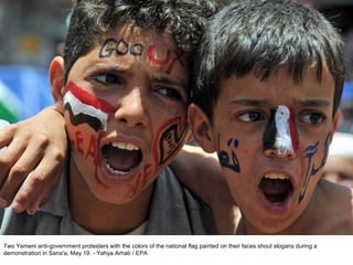 Two Yemeni anti-government protesters with the colors of the national flag painted on their faces shout slogans during a demonstration in Sana'a, May 19. - Yahya Arhab / EPA  