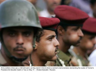 Army soldiers chew qat, a mild stimulant, as they stand in line to block a women's demonstration demanding the ouster of Yemen's President Ali Abdullah Saleh in Taiz on May 17.  - Khaled Abdullah / Reuters  
