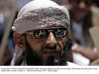 A supporter of Yemeni President Ali Abdullah Saleh wearing sunglasses painted with the slogan "Don't leave Ali" takes part in a pro-regime rally in Sanaa on May 13.  - Mohammed Huwais / AFP - Getty Images  