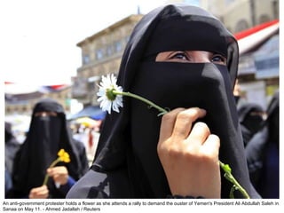 An anti-government protester holds a flower as she attends a rally to demand the ouster of Yemen's President Ali Abdullah Saleh in Sanaa on May 11. - Ahmed Jadallah / Reuters  