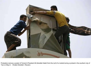 Protesters remove a poster of Yemen's President Ali Abdullah Saleh from the roof of a market during a protest in the southern city of Taiz on May 8.  - Khaled Abdullah / Reuters  