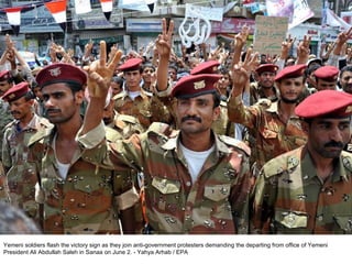 Yemeni soldiers flash the victory sign as they join anti-government protesters demanding the departing from office of Yemeni President Ali Abdullah Saleh in Sanaa on June 2. - Yahya Arhab / EPA  