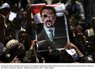 Anti-government protesters hold a picture of President Ali Abdullah Saleh depicting him as a pirate during a demonstration calling for his ouster in Sanaa on April 20. - Mohammed Huwais / AFP - Getty Images  