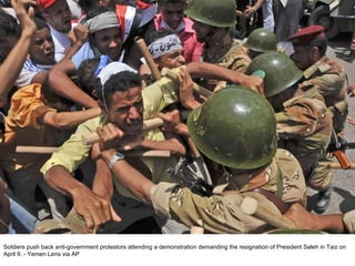 Soldiers push back anti-government protestors attending a demonstration demanding the resignation of President Saleh in Taiz on April 9. - Yemen Lens via AP  