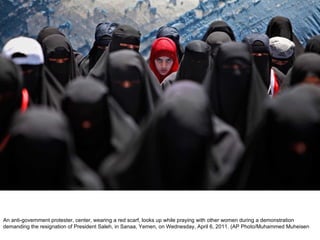 An anti-government protester, center, wearing a red scarf, looks up while praying with other women during a demonstration demanding the resignation of President Saleh, in Sanaa, Yemen, on Wednesday, April 6, 2011. (AP Photo/Muhammed Muheisen  