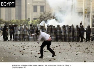 An Egyptian protester throws stones towards a line of riot police in Cairo on Friday. – Victoria Hazou / AP  